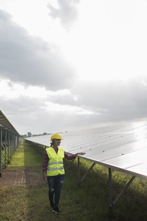Engineer electric woman checking and maintenance of solar cells.